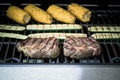 Rib eye steak with zucchini and corn on grill