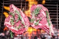 Rib eye steaks and grill with burning fire. Royalty Free Stock Photo