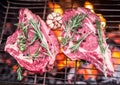 Rib eye steaks and grill with burning fire. Royalty Free Stock Photo