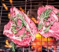 Rib eye steaks and grill with burning fire. Royalty Free Stock Photo