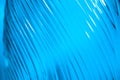 Ribbed glass with wavy pattern illuminated in blue light. Creating volume with light. Abstract background with copy Royalty Free Stock Photo