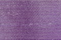 Ribbed texture of purple reflective shiny wall. Shining pink convex foil background. Abstract glitter pattern. Reflective violet s