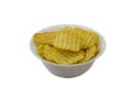Ribbed yellow potato chips in bowl isolated on white background Royalty Free Stock Photo