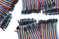 Ribbon cable or multi-wire planar cable on white background. Flat ribbon cable with pin connectors. Multi-colored ribbon computer