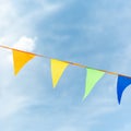 Ribbon made of multicolored triangles against the sky