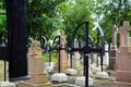 Ribbon with national colours of Poland tied up to the old cross on the cemetery. National day concept.