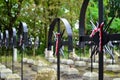 Ribbon with national colours of Poland tied up to the old cross on the cemetery. Uprising concept.