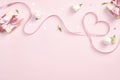 Ribbon in shape of heart with gift boxes and rose flowers on pink background. Happy Valentines day, Mothers day, birthday concept Royalty Free Stock Photo