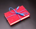 Ribbon from the usb cable on book as a present Royalty Free Stock Photo