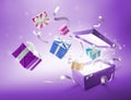 Ribbons and gifts bursting out from purple gift box Royalty Free Stock Photo