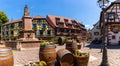 Panorama of the historic village center of Ribeauville with fountain and wine casks in the village square