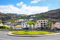 Ribeira Brava, Madeira, Portugal - Sep 9, 2019: Picturesque village with palm trees by the road. Houses on the hill in the