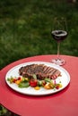 Ribeye beef steak with vegetable salad and wine Royalty Free Stock Photo