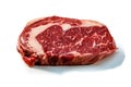 Ribeye. A raw marbled beef steak sits on a white background with a shadow