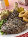 Ribeye Steak on the bone with Baked Potato Royalty Free Stock Photo