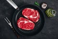 Ribeye Steak, Raw fresh beef meat with salt and rosemary in grill pan Royalty Free Stock Photo