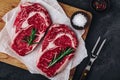 Ribeye Steak, Raw fresh beef meat with salt and rosemary ready for barbecue Royalty Free Stock Photo