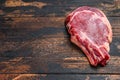 Ribeye steak. Raw Marble beef black Angus, rib eye. Dark wooden background. Top view. Copy space Royalty Free Stock Photo