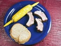 Ribs, Corn on the cob on a blue plate Royalty Free Stock Photo