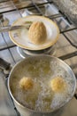 Rice balls frying in boiling oil Royalty Free Stock Photo