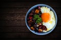 Rice in a bowl with sunny side up egg and fried chicken with black pepper sauce Royalty Free Stock Photo