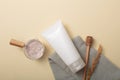 Rice bran powder is stored in glass bowl. A tube of unbranded facial cleanser, a cloth and a honey drizzle are displayed on a Royalty Free Stock Photo