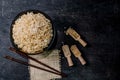 Rice brown in bowl have grain in spoon on black wood background. Royalty Free Stock Photo