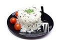 Rice with cherry tomatoes and greens on a black plate Royalty Free Stock Photo