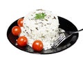 Rice with cherry tomatoes and greens on a black plate Royalty Free Stock Photo