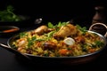 Rice with chicken and vegetables on black background. Indian cuisine, Indian chicken biryani with rice and vegetables on a black Royalty Free Stock Photo