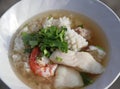Rice congee mixed with Shrimp, fish, squid and pork, Garnish with coriander. Royalty Free Stock Photo
