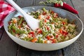 Rice cooked with vegetables and olive oil in a frying pan.