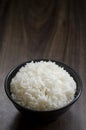 Rice in cup on wooden table wth copy space