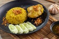 Rice with curried chicken. Delicious spicy chicken biryani in black bowl on wooden background, Indian or Pakistani ramzan food. Ho Royalty Free Stock Photo