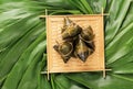 Rice dumpling, zongzi - Traditional Chinese food on green leaf background of Dragon Boat Festival, Duanwu Festival