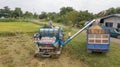 Rice farm on harvesting season by farmer with combine harvesters