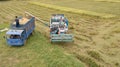 Rice farm on harvesting season by farmer with combine harvesters