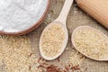 Rice flour in bowl, unpolished rice, brown rice in wooden spoon. The whole grain of rice. Unpolished rice and red rice on canvas Royalty Free Stock Photo