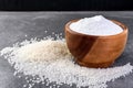 Rice flour in wooden bowl on gray background. Royalty Free Stock Photo