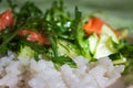 Rice with fresh salade and raw salmon close up. Rucola with cucamber and fish with rice. Healthy tasty food. Rice with vegetables.