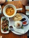 Rice with fried beef and coconut milk soup & x28;soto gongso& x29;