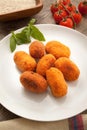 Rice fried croquettes dish in wooden background