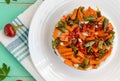 Rice and fried vegetables asparagus beans, carrots - vegan diet garnish. Decorated layers of salad on a white plate. Royalty Free Stock Photo