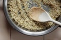 Rice frying and oiling in ghee on steel pan closeup, process of cooking asian indian basmati ghee rice