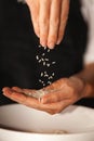 Rice grains fall from one hand to another Royalty Free Stock Photo