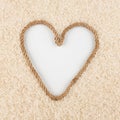 Rice grains and a rope in the shape of a heart with a place for designers. Royalty Free Stock Photo