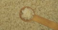 Rice grains in a spoon. Refocusing from a spoonful of grain to a pile of grain. Rotation.