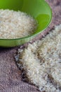 Rice in green plate on sacking Royalty Free Stock Photo