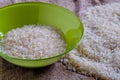 Rice in green plate on sacking Royalty Free Stock Photo