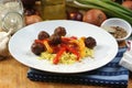 rice with grilled meatballs on a plate